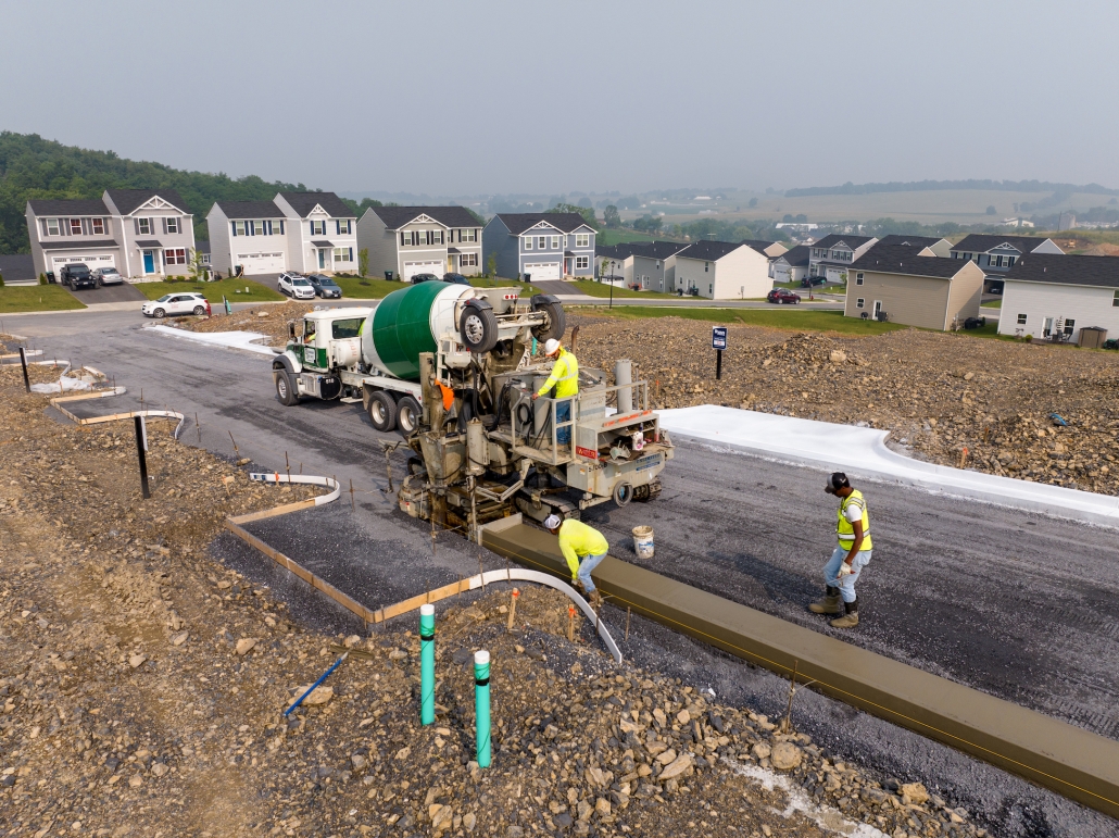 Concrete Paving Construction Crew In New Neighborhood